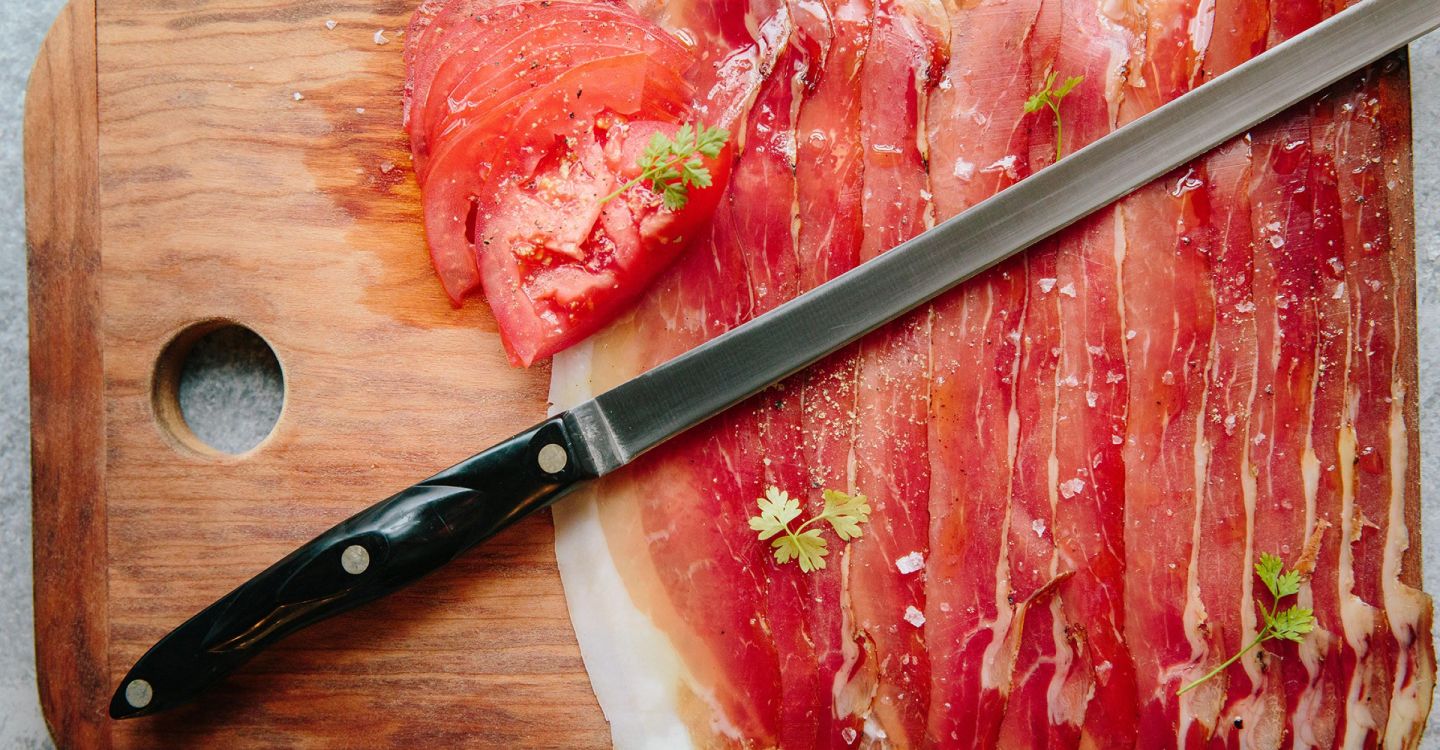 A Knife Cutting A Piece Of Meat